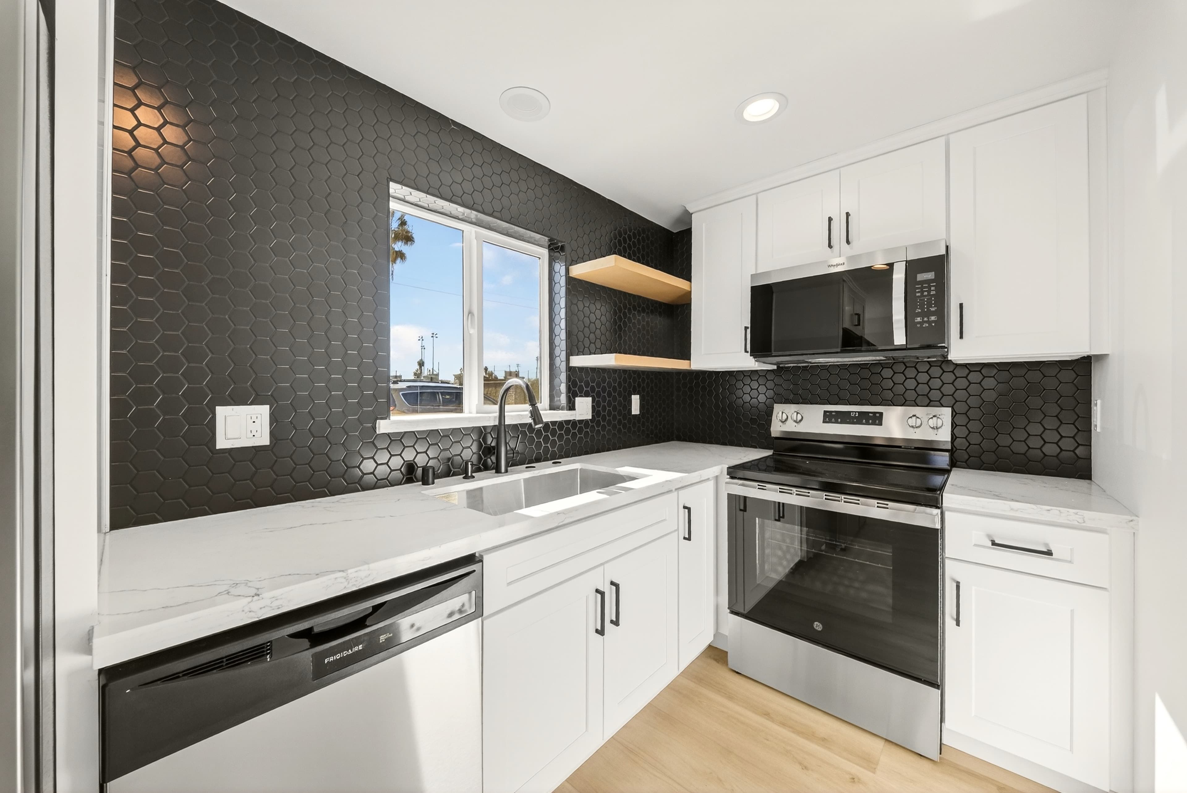 Unit kitchen with hex tile backsplash