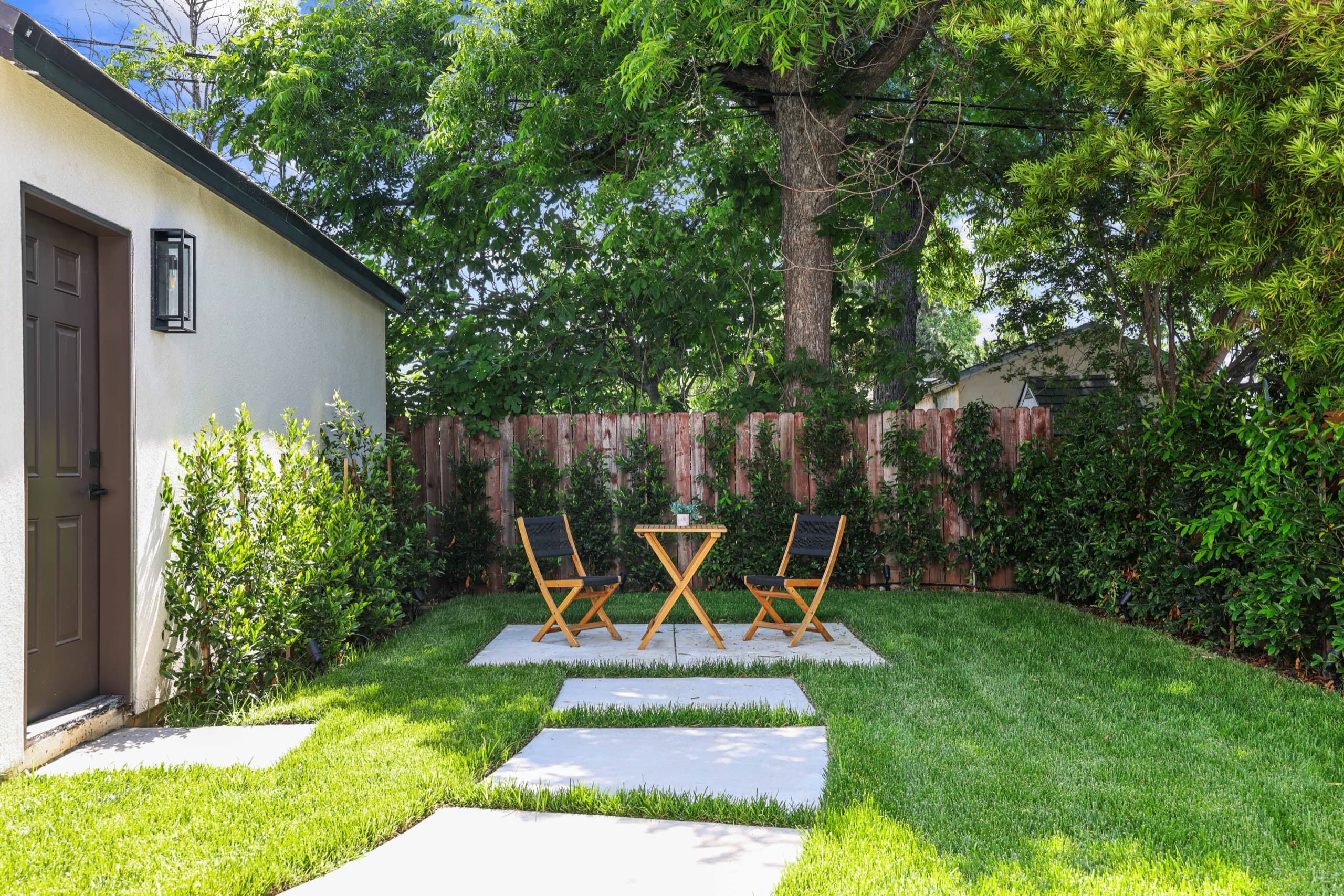 Backyard patio with paver path and lawn
